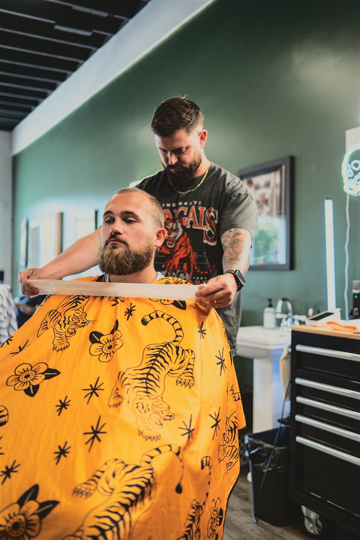 A barber preparing a client at Greensborough Barber Company