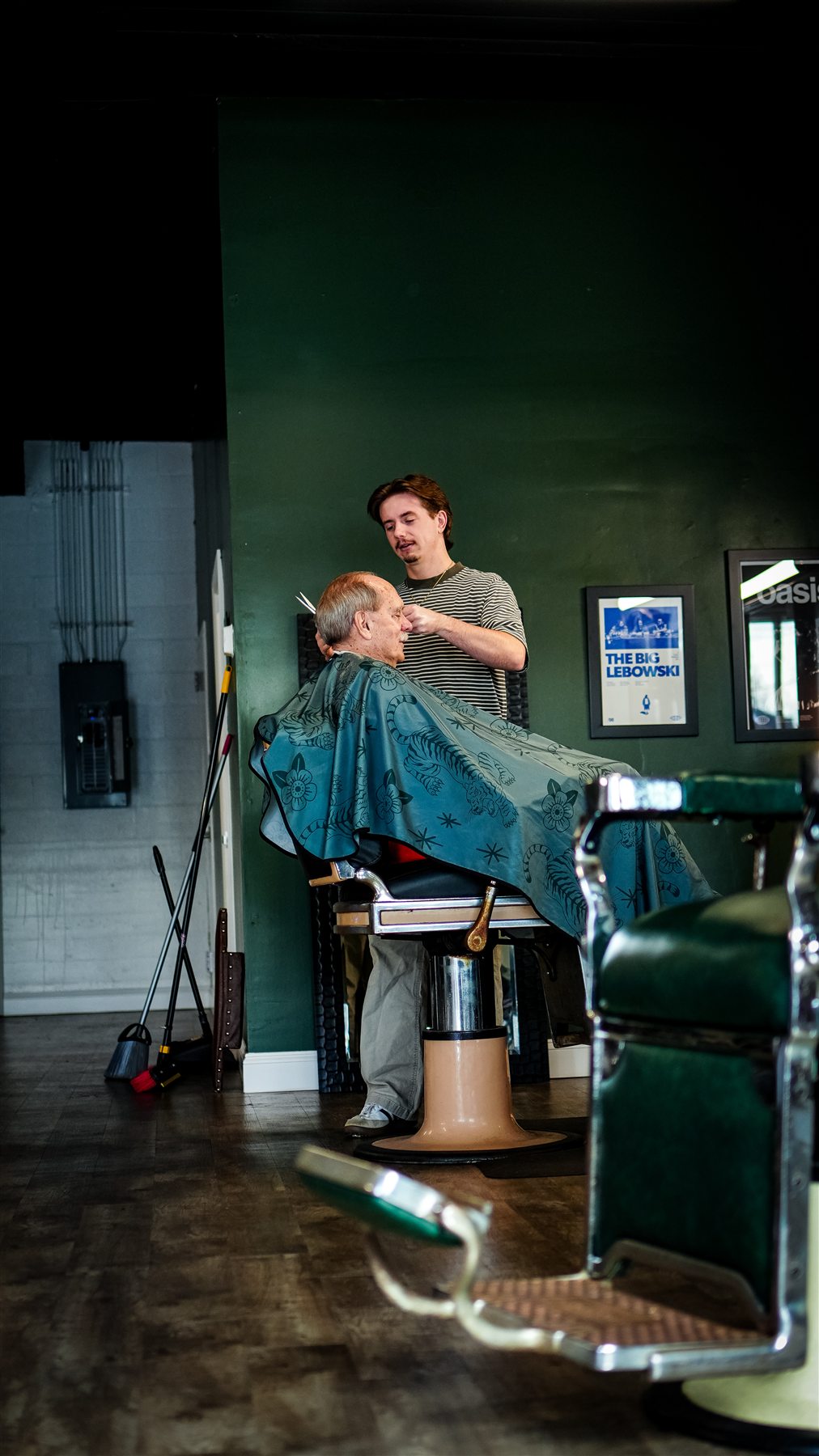A Greensborough barber using scissors to shape a client's cut with precision