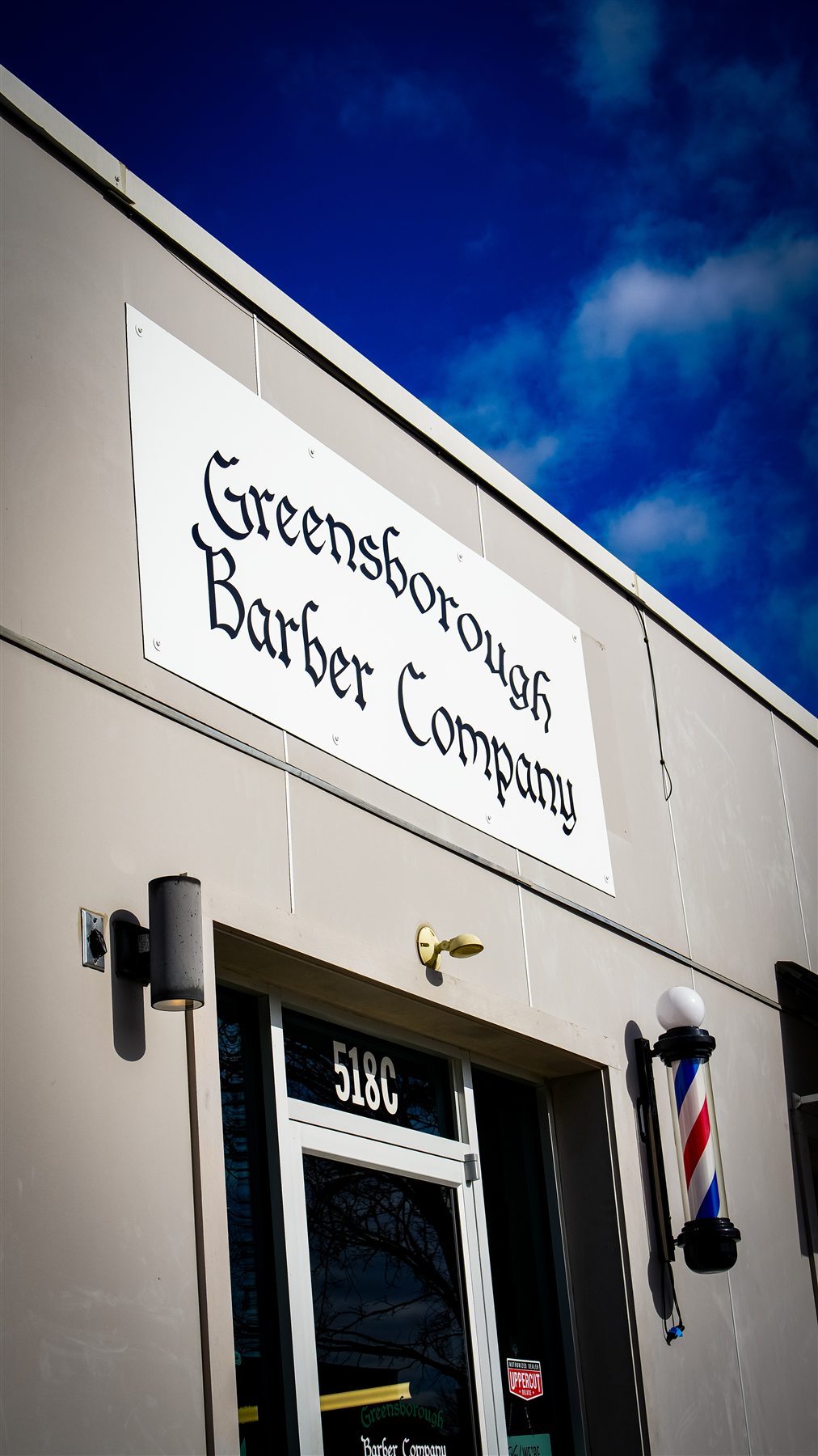 The Greensborough Barber Company storefront at 518 North Spring Street